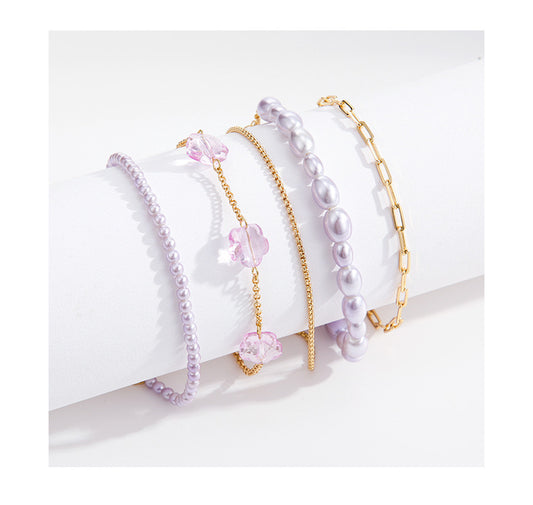 PURPLE LAYERED SET-5 BRACELET WITH MIXED CHAIN,SIMULATED PEALS & RESIN FLOWER 18K gold-plated for color retention.